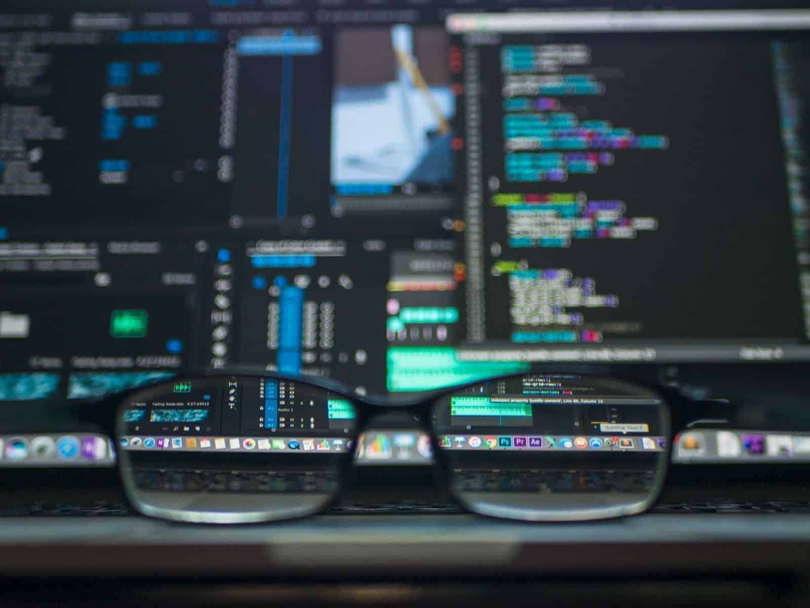 Computer screen and spectacles, being used to read SQL Coding Articles with Cambridge Coding Courses.